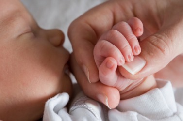 A mother holds her babys' hand. A mother holds her babys' hand.