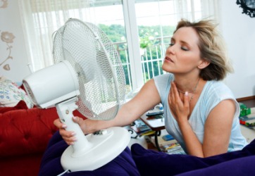A woman tries to cool off on a hot day. A woman tries to cool off on a hot day.