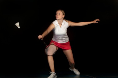 A woman playing badminton. A woman playing badminton.