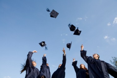 Graduates hurl their caps in the air. Graduates hurl their caps in the air.