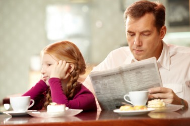 A father and daughter ignore each other. A father and daughter ignore each other.