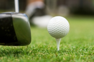 A golf club about to impact the ball. A golf club about to impact the ball.