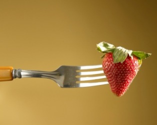 A strawberry impaled by a fork. A strawberry impaled by a fork.