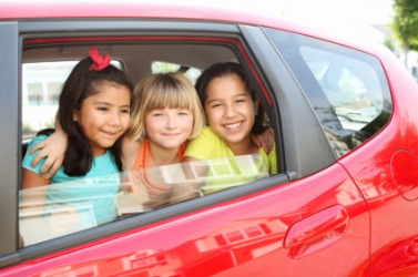 These three children are in the car. These three children are in the car.