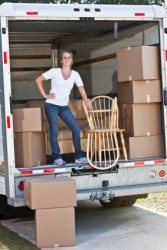 This woman is inside the back of this truck. This woman is inside the back of this truck.