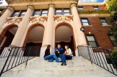 Students sitting outside their school. Students sitting outside their school.