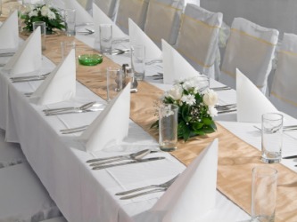A table set in preparation for a banquet. A table set in preparation for a banquet.