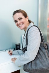 A woman making a deposit in her bank. A woman making a deposit in her bank.