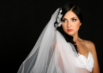 A bride wearing a veil. A bride wearing a veil.