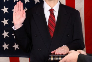 A man swears an oath in court. A man swears an oath in court.