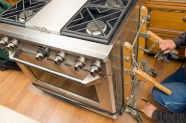 A kitchen being updated with a new appliance. A kitchen being updated with a new appliance.