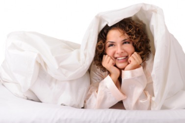 A woman covers herself with a blanket. A woman covers herself with a blanket.
