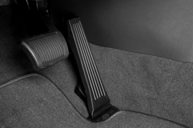 This cars brake pedal is the one on the left. This cars brake pedal is the one on the left.