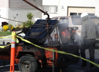Pitch being heated before applying it to a roof. Pitch being heated before applying it to a roof.
