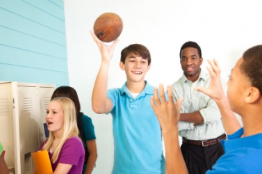 This boy is about to toss a ball to a friend. This boy is about to toss a ball to a friend.