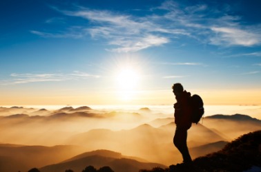 A hiker enjoys a beautiful view. A hiker enjoys a beautiful view.