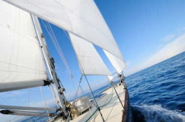 A sailboat propelled by a nautical breeze. A sailboat propelled by a nautical breeze.