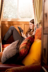 A girl sits reading in a neuk. A girl sits reading in a neuk.
