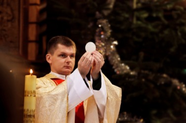A priest officiates over communion. A priest officiates over communion.