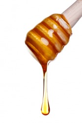 Honey oozes frmo a dipper. Honey oozes frmo a dipper.