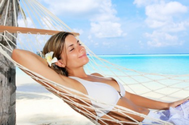 A woman basking in a hammock. A woman basking in a hammock.