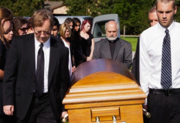 Pallbearers carry a coffin at a funeral. Pallbearers carry a coffin at a funeral.