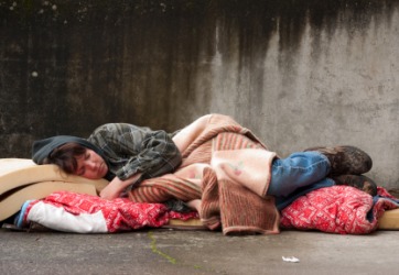 A pauper sleeps on the street. A pauper sleeps on the street.