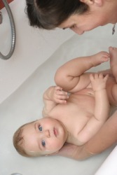 A mother about to bathe her baby. A mother about to bathe her baby.