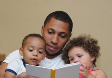 A father reads to his children. A father reads to his children.