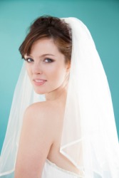A bride wearing a veil. A bride wearing a veil.