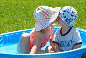 Two children in a wading pool. Two children in a wading pool.