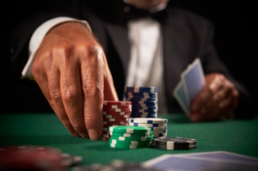 A card player makes a wager. A card player makes a wager.