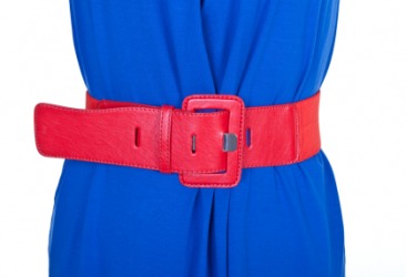 A red belt around a womans waist. A red belt around a womans waist.