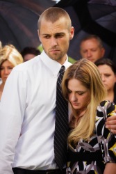 A couple weep at a funeral. A couple weep at a funeral.