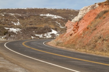 A hillside abuts the road. A hillside abuts the road.