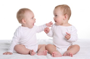 Two babies babble at each other. Two babies babble at each other.