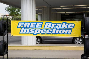 A banner announcing brake inspections at a tire shop. A banner announcing brake inspections at a tire shop.