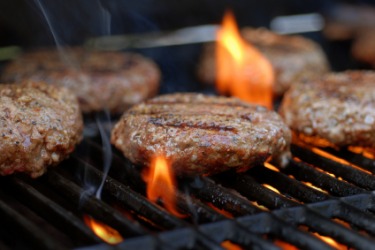Barbequing hamburgers. Barbequing hamburgers.