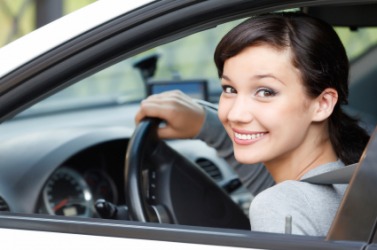 A young woman behind the wheel. A young woman behind the wheel.