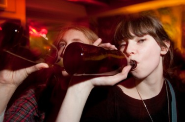 A woman binge drinking. A woman binge drinking.