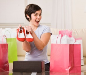 A woman shows off her pair of brand-new shoes. A woman shows off her pair of brand-new shoes.