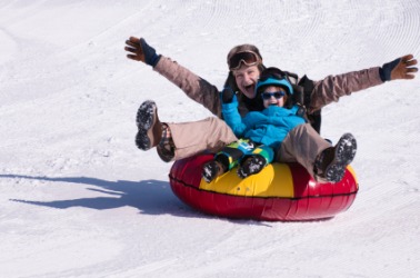 Two people careen down a snowy hill. Two people careen down a snowy hill.