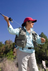 A woman about to cast her fishing line. A woman about to cast her fishing line.