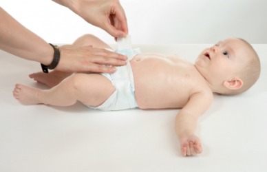 A baby has it's didie changed. A baby has it's didie changed.