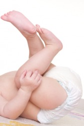 A baby wearing only a didy. A baby wearing only a didy.