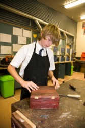 A student fabricates a box in woodworking class. A student fabricates a box in woodworking class.