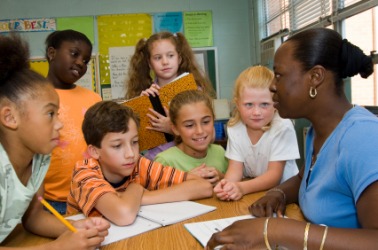 A teacher helps her students to learn. A teacher helps her students to learn.