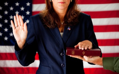 A woman swears an oath. A woman swears an oath.