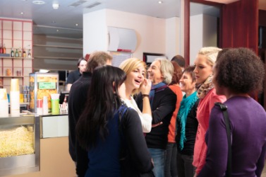 People queued up at a cinema concession stand. People queued up at a cinema concession stand.
