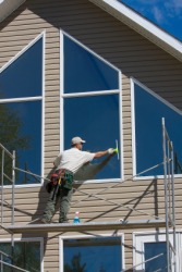 A window washer on a scaffold. A window washer on a scaffold.
